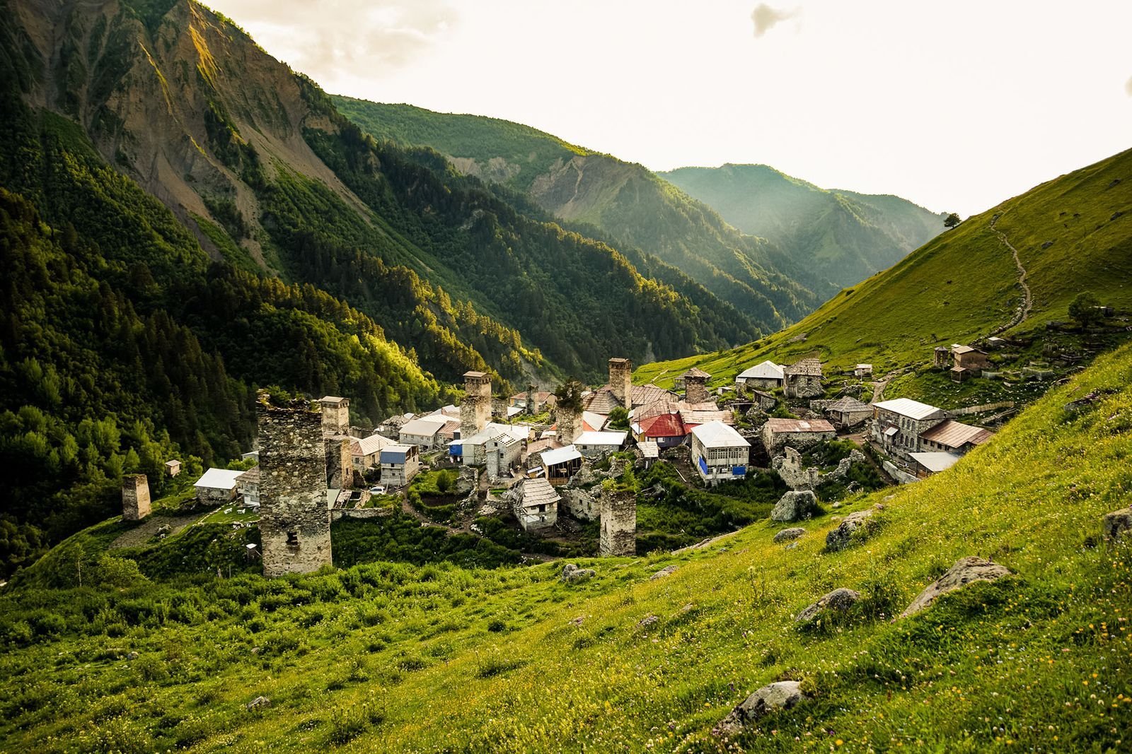 Adishi village with Svan towers on a green hillside