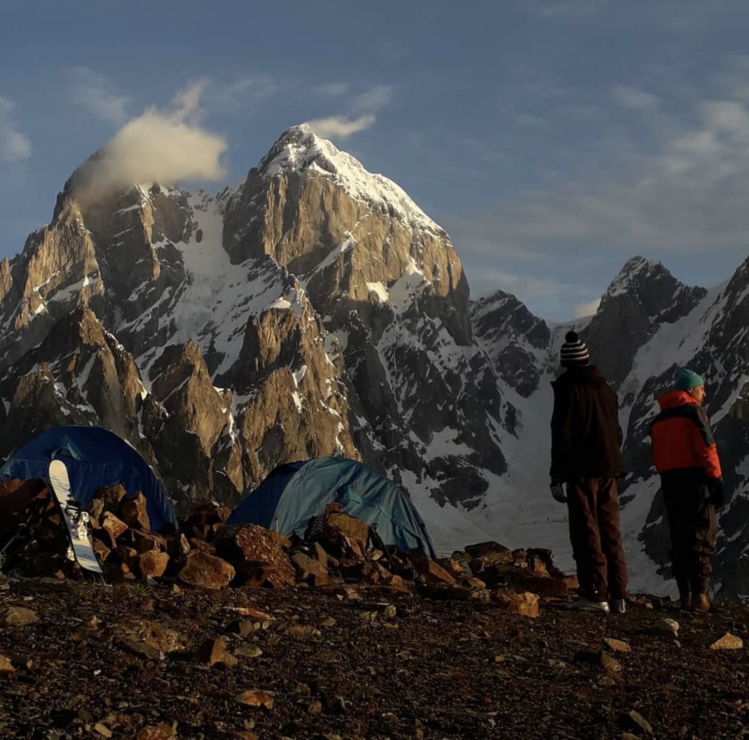Tents at a mountain basecamp under a peak