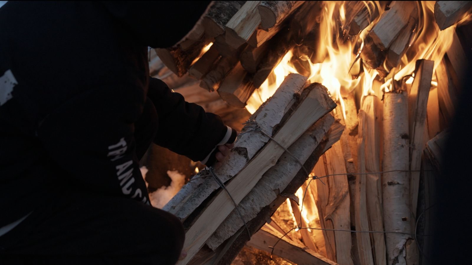 Birch logs burning at a winter festival