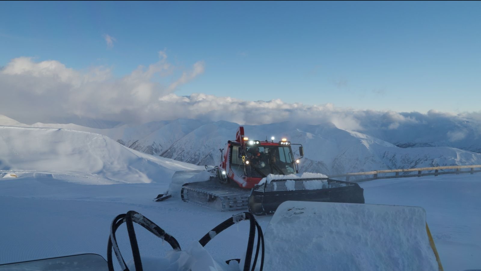 Snowcat on the ridge at dawn