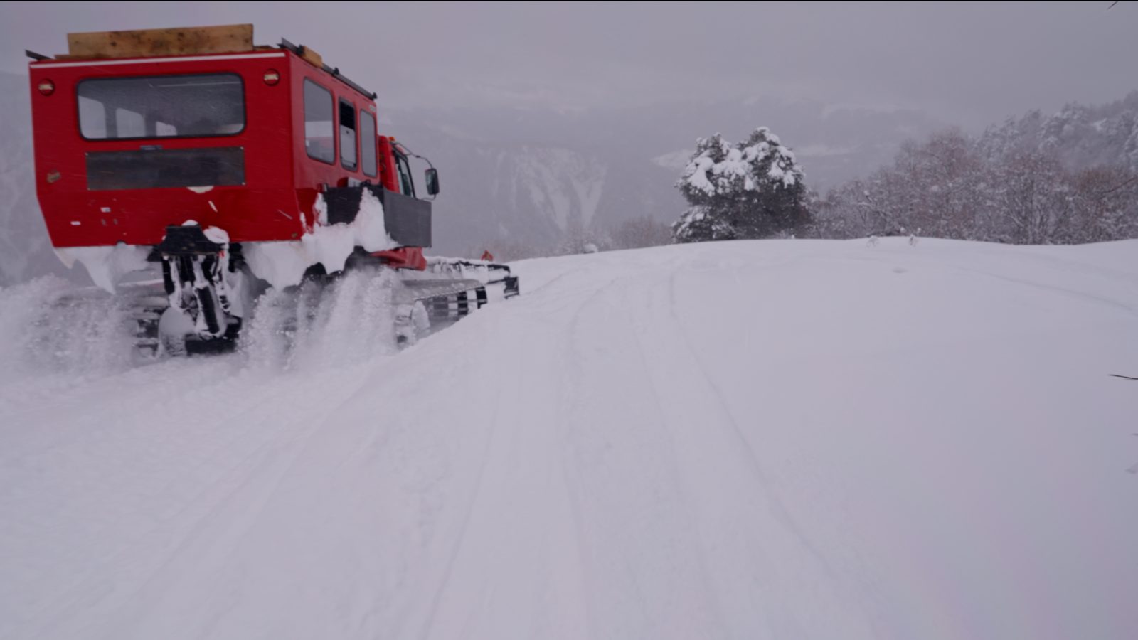 Catski route towards Koruldi — groomed track at dawn above Mestia