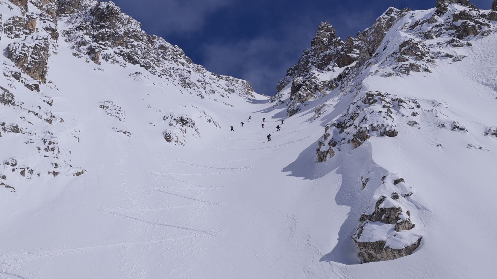 Group climbing a wide couloir