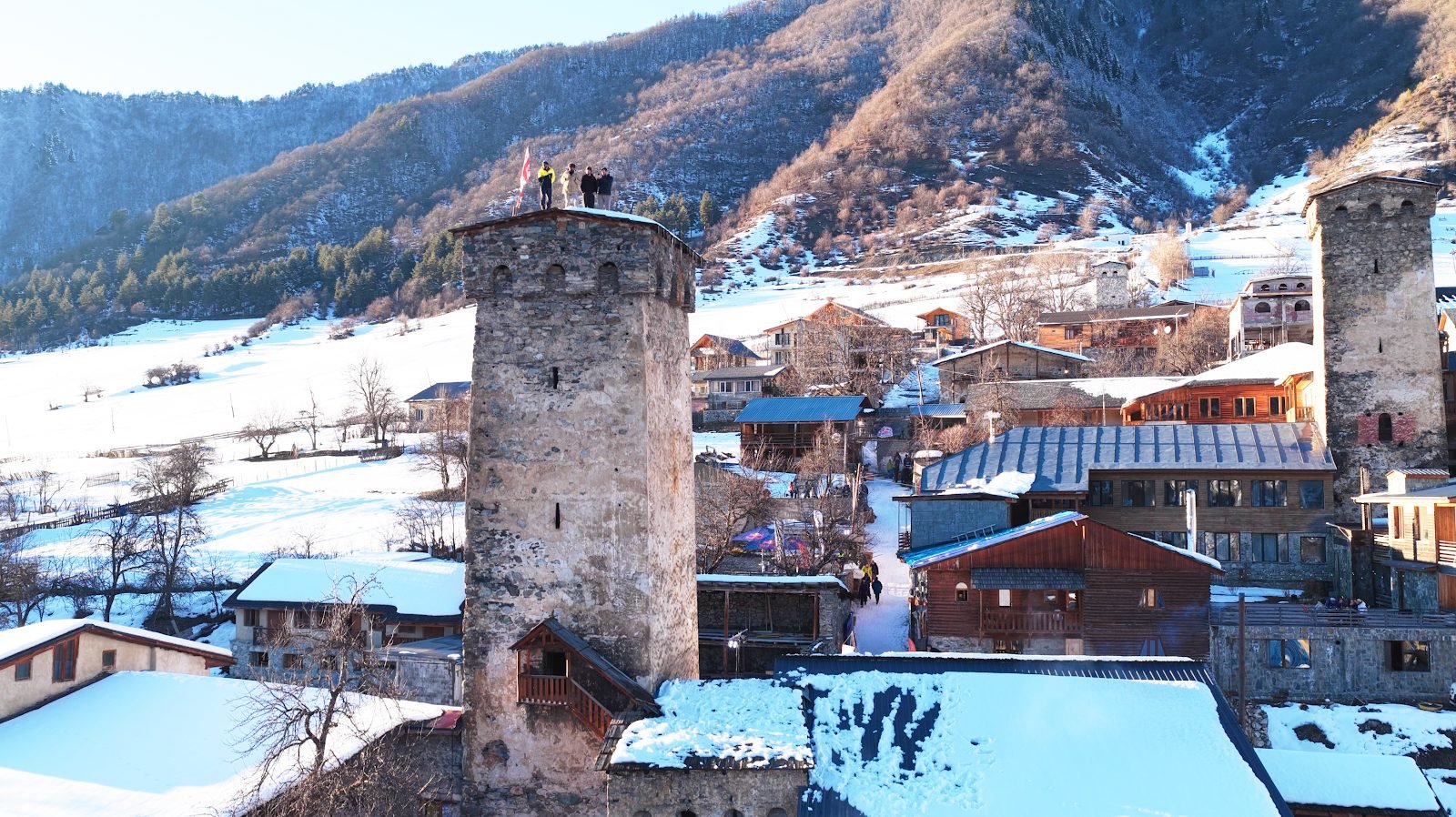 Stone tower and village houses in winter