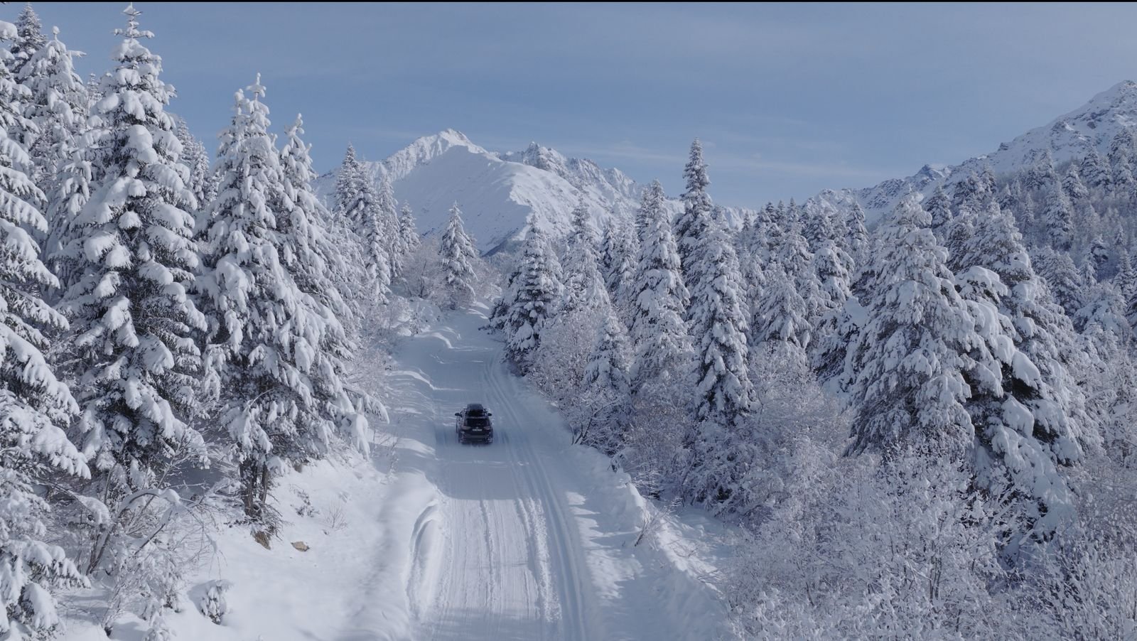Transfer driving the winter road through the forest