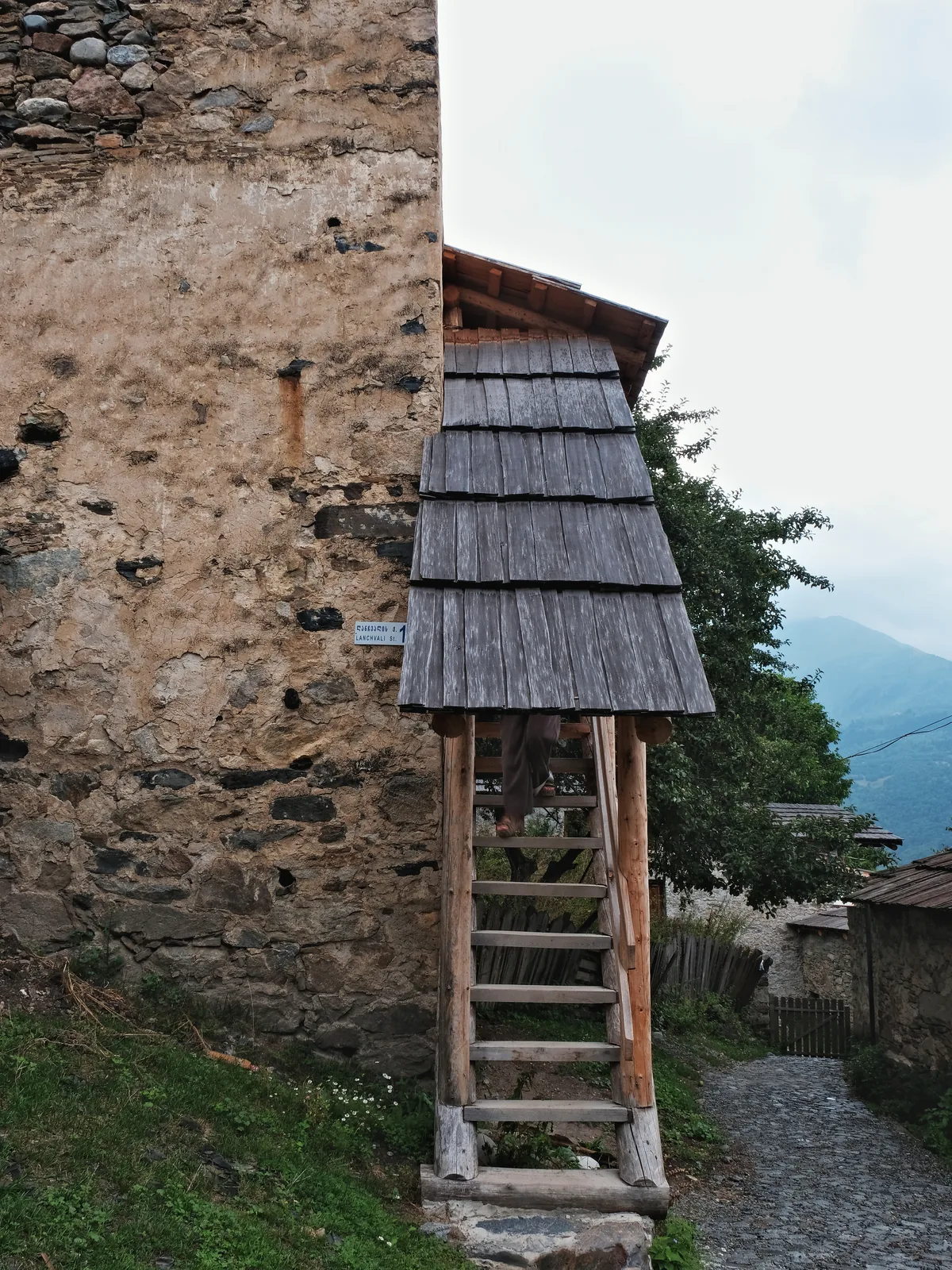 A wooden ladder leading to the entrance of a Svan tower.