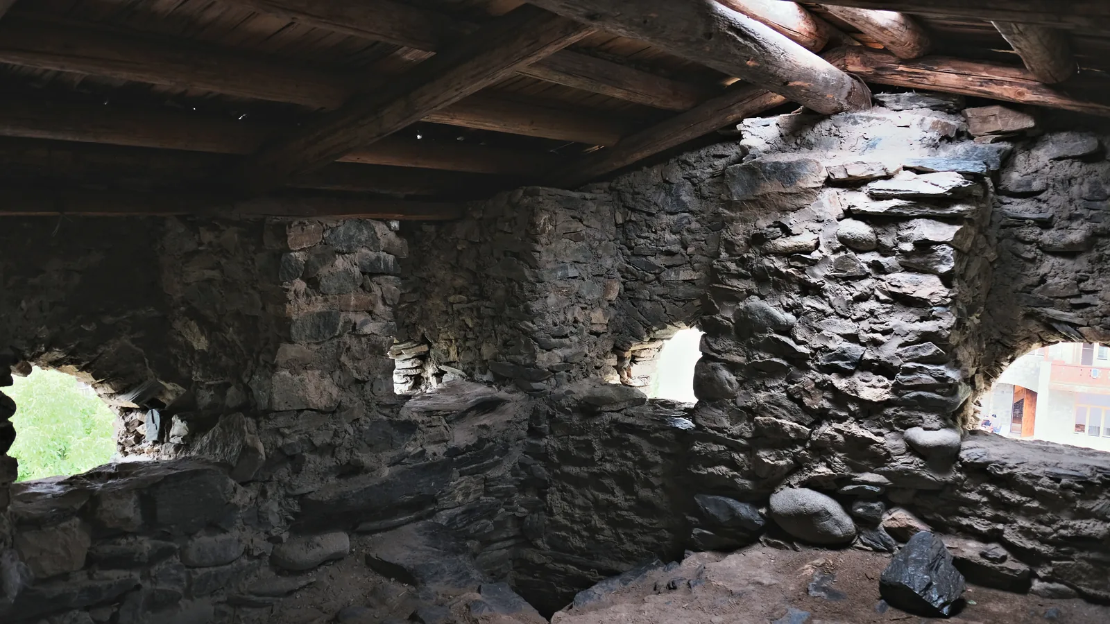 Stone walls and wooden roof beams on a Svan tower’s upper floor.