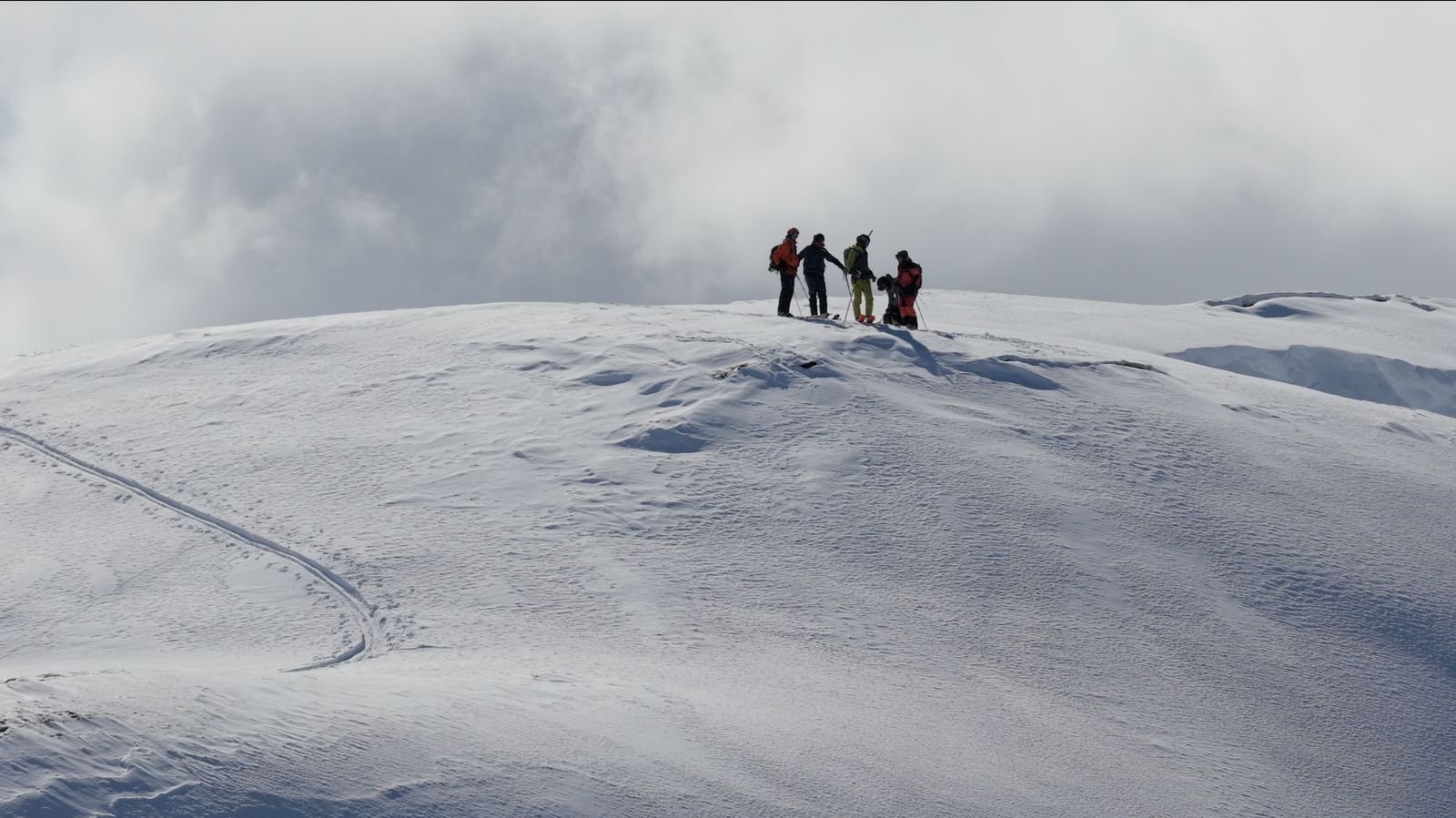 Group resting on a broad summit