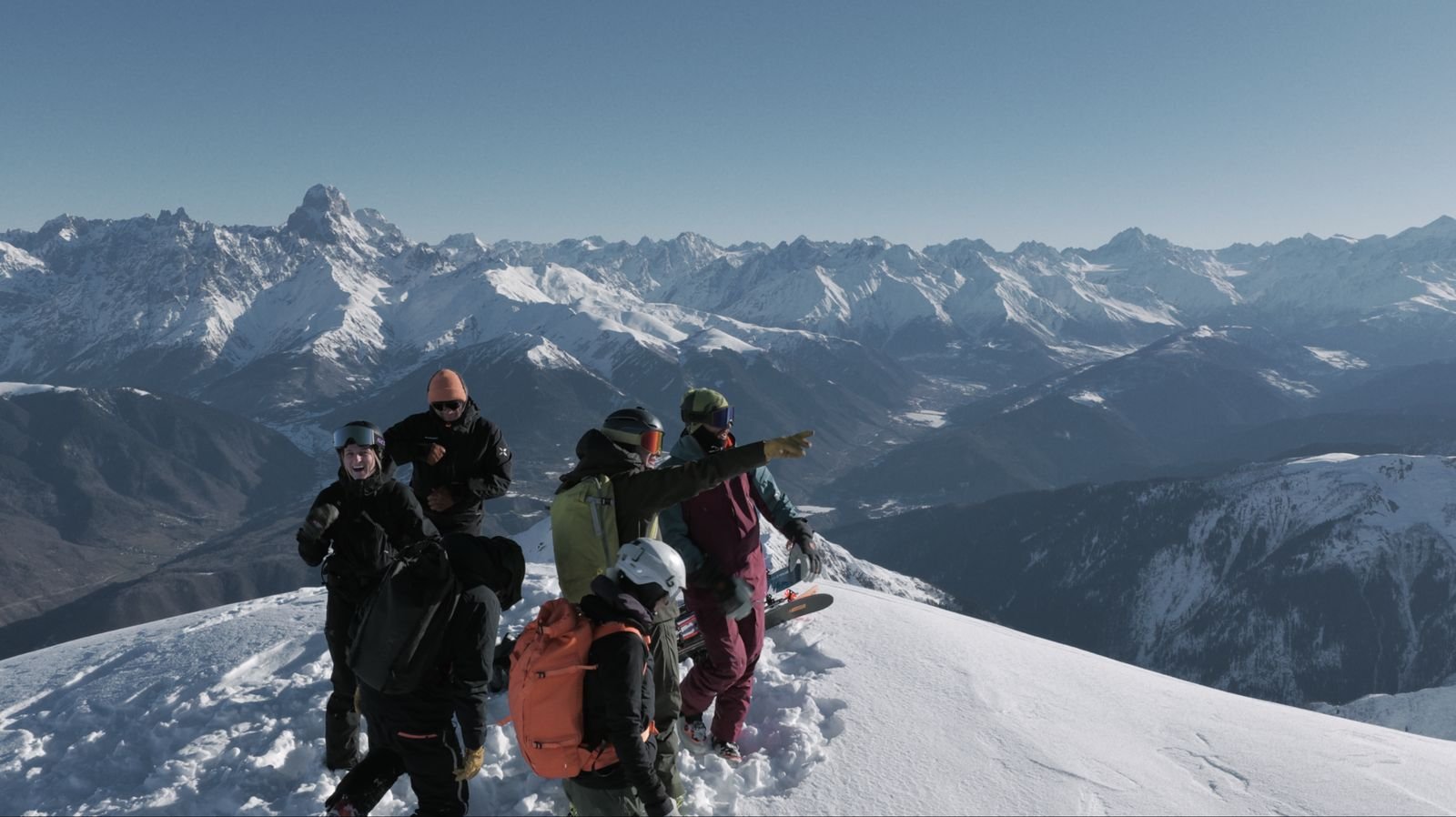 Ski tourers on a summit ridge with Ushba behind, Svaneti