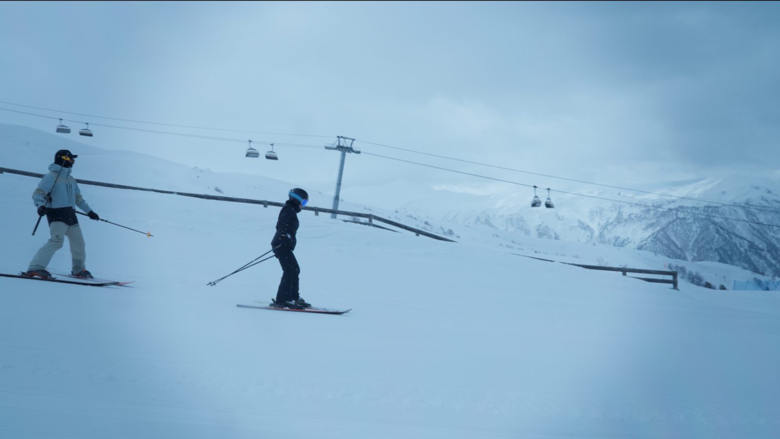 Ski lesson on Tetnuldi — instructor guiding a beginner on wide empty pistes