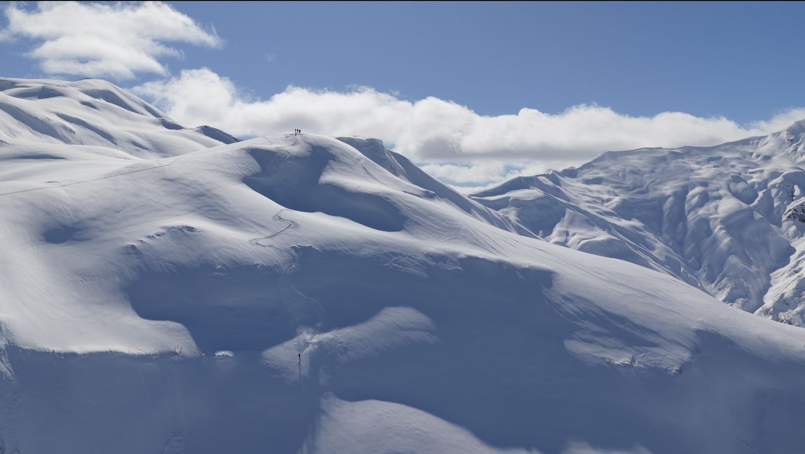 Wide open snowfield above the valley