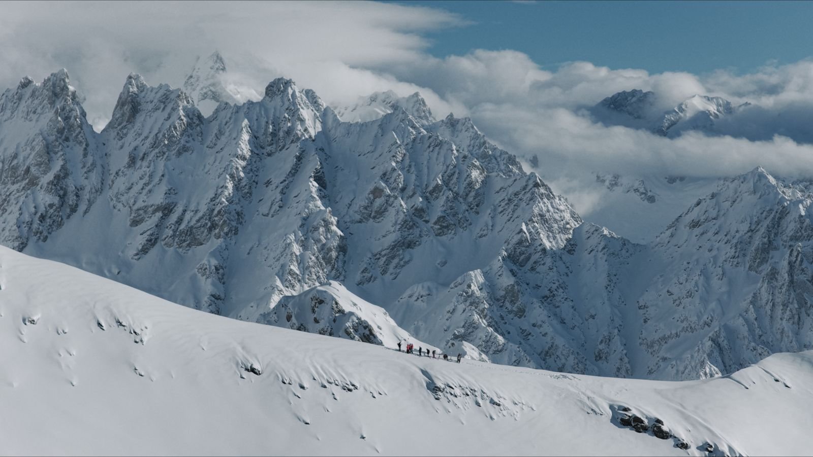 Stone church in front of the snow-capped Caucasus ridge in Svaneti