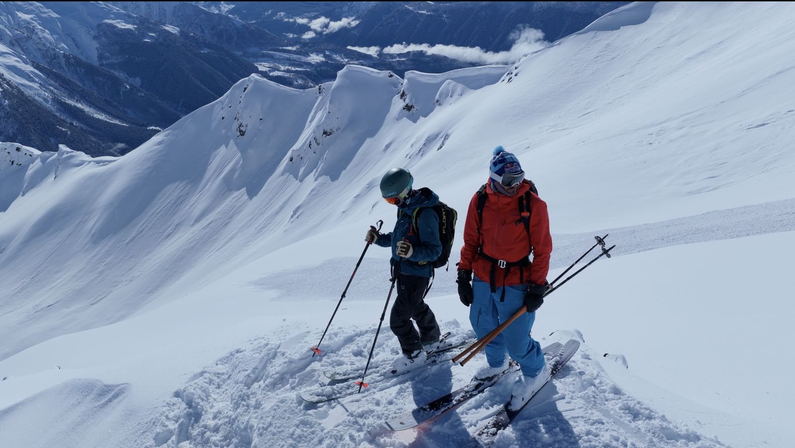 Two skiers dropping into a Tetnuldi slope