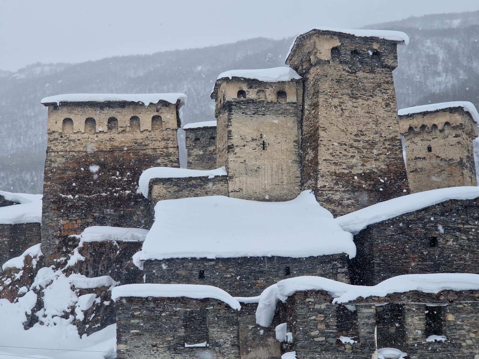 Svan towers of Ushguli under heavy snowfall