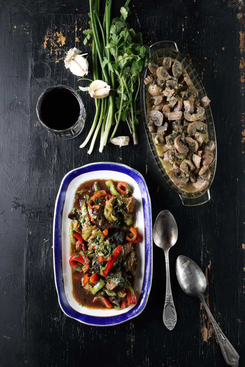 Vegetable dishes, mushrooms, fresh herbs and a glass of red wine